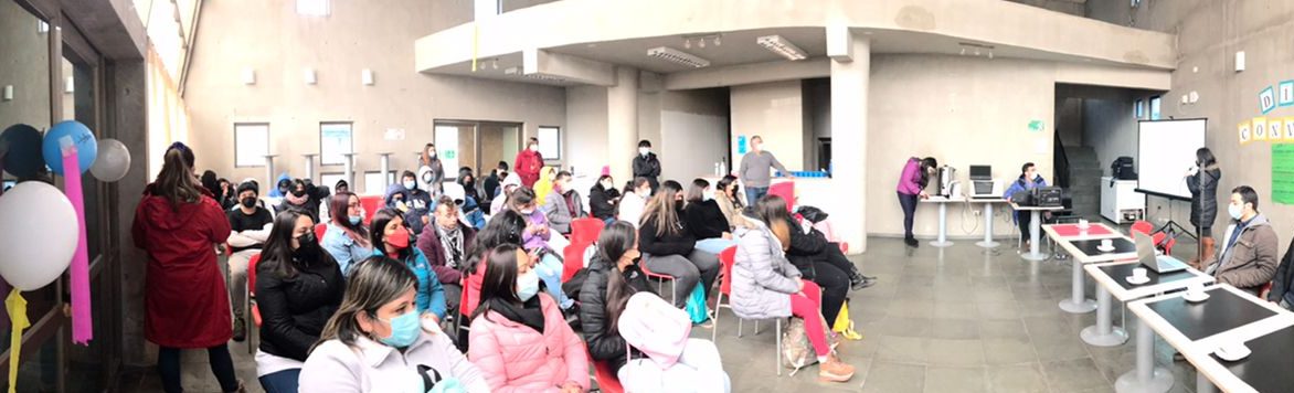 Rear view of kids raising hands while teacher explaining the fun